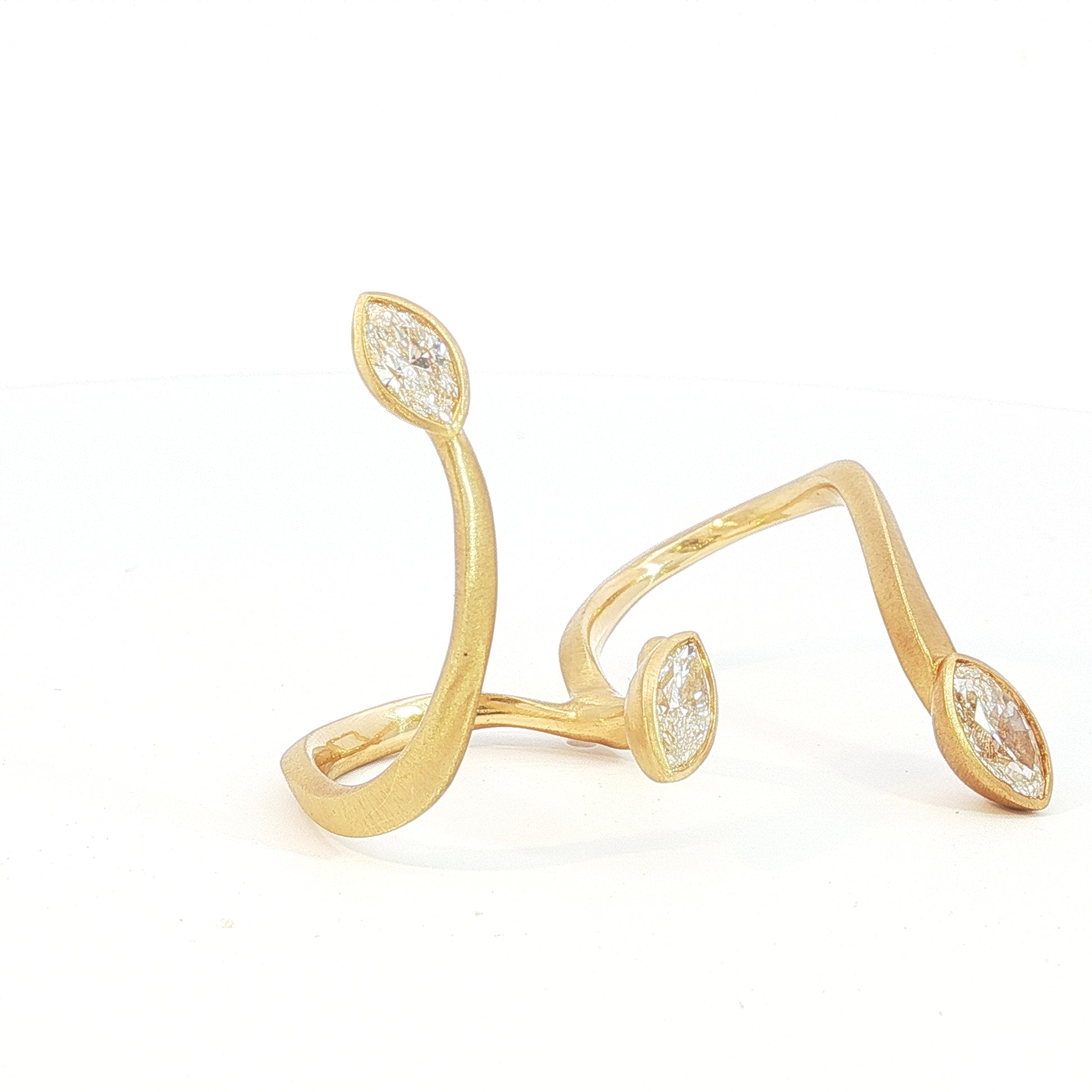Avant-garde 18k matte yellow gold open-shank ring with 1.53ctw marquise diamonds worn across fingers size 7 by Kantor Gems