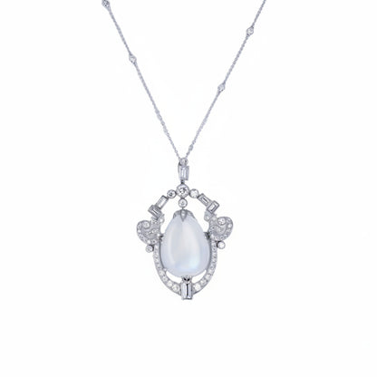 platinum pendant necklace featuring a pear-shaped cabochon moonstone framed by 2.75 CTW of baguette & round diamonds. 11.13 grams.