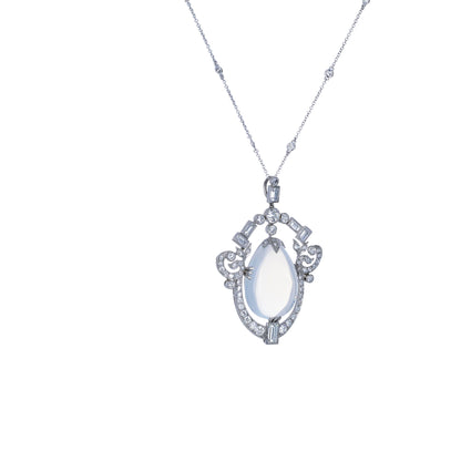 platinum pendant necklace featuring a pear-shaped cabochon moonstone framed by 2.75 CTW of baguette & round diamonds. 11.13 grams.