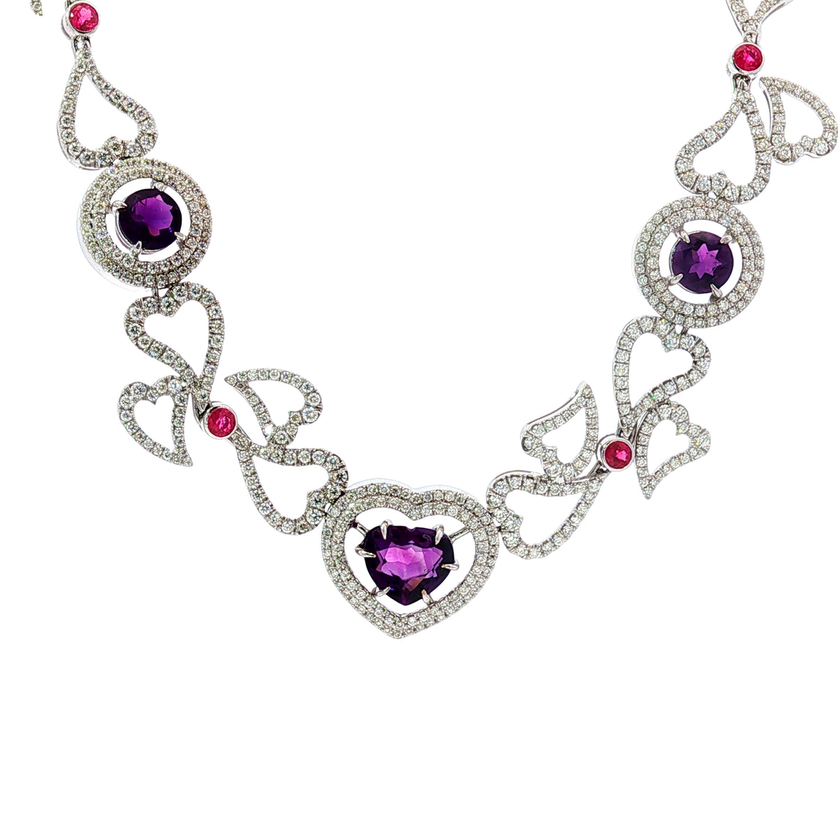14K white gold heart necklace featuring 14.45 carats of amethysts and 9.00 carats of diamonds in an intricate openwork design.
