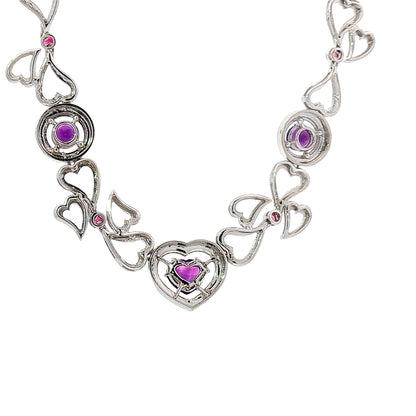 14K white gold heart necklace featuring 14.45 carats of amethysts and 9.00 carats of diamonds in an intricate openwork design.