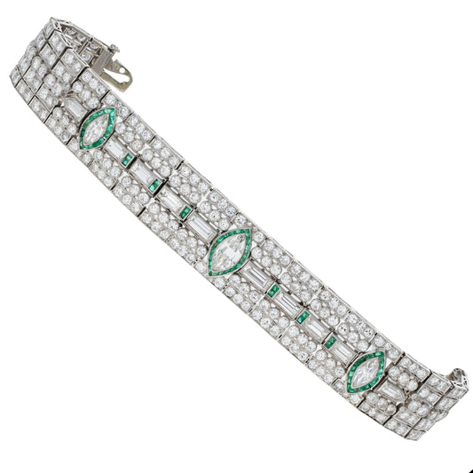 Elegant Art Deco bracelet with emeralds and diamonds on a white background