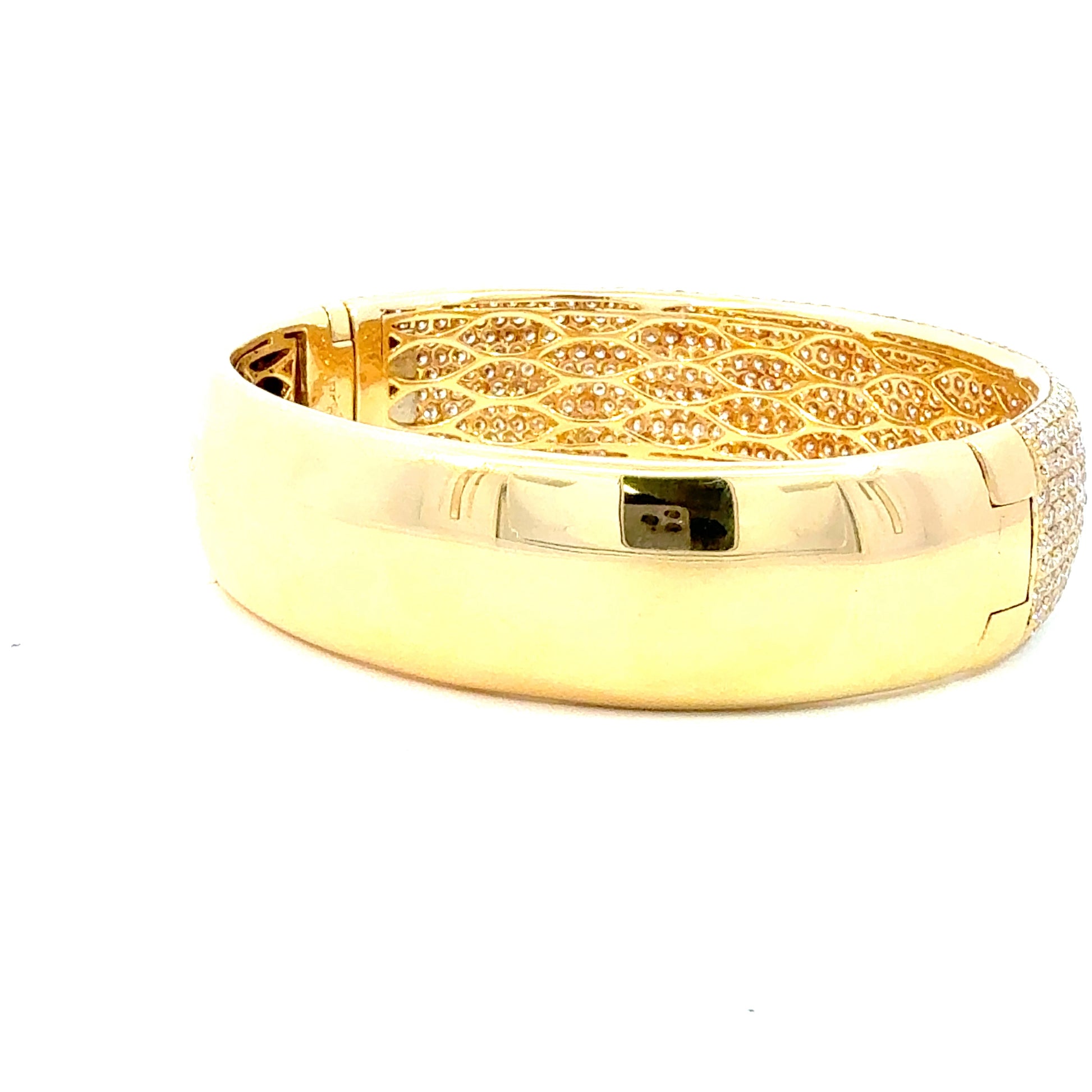Gold bracelet with intricate design on a white background
