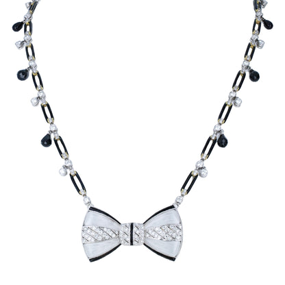 Fred Leyton 18K gold necklace with rock crystal bow pendant, black onyx links, bezel-set diamonds, and briolette black diamond drops.