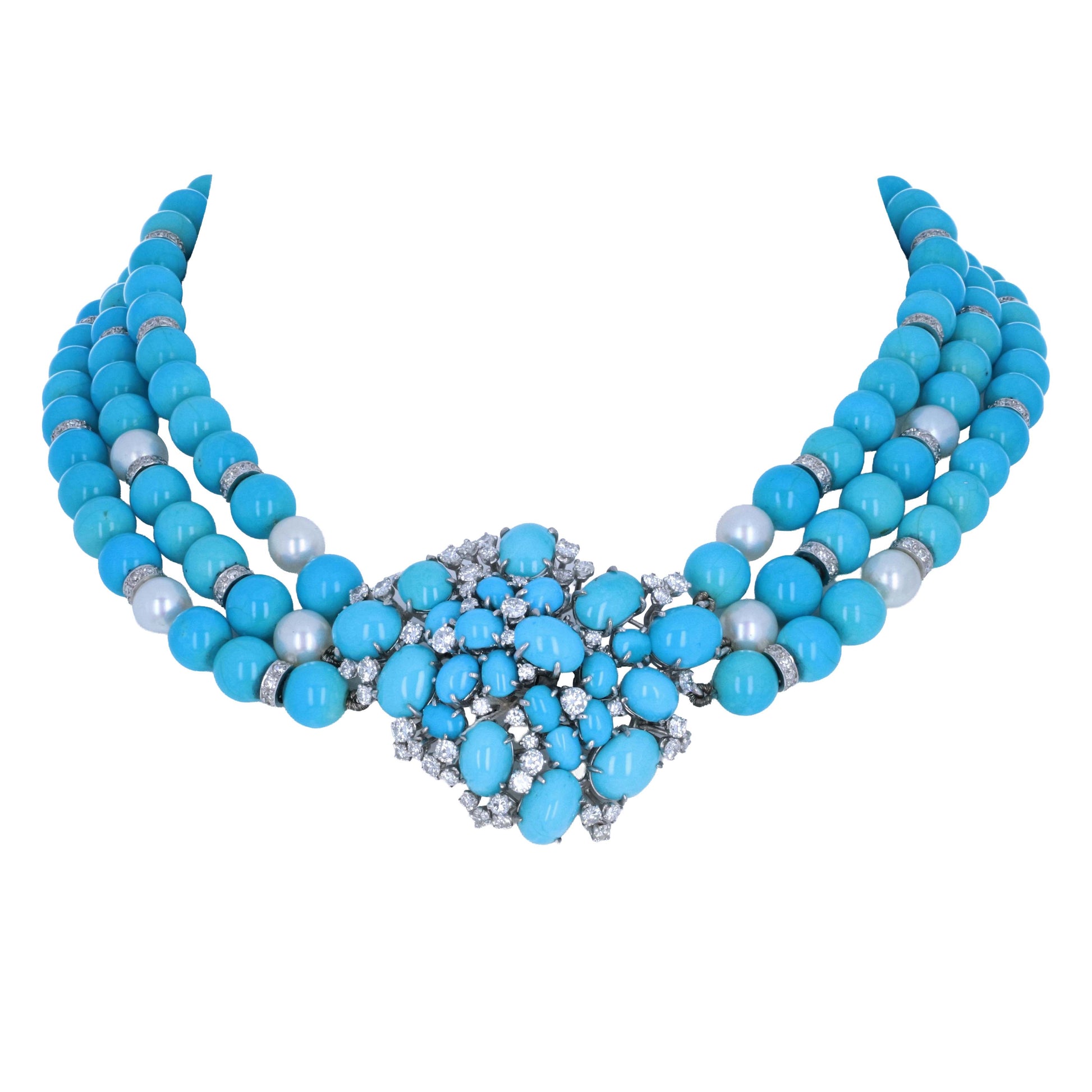 meisterA multi-strand statement necklace featuring bright turquoise-blue beads, silver-toned spacer rings, and a large central floral cluster of turquoise and clear rhinestones on a white background.
