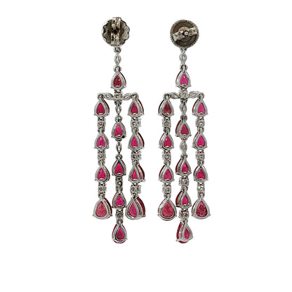 Pear shape ruby and diamond chandelier dangle earrings in 18 karat white gold with 9.98 carats of natural rubies and 1.02 carats of diamonds.