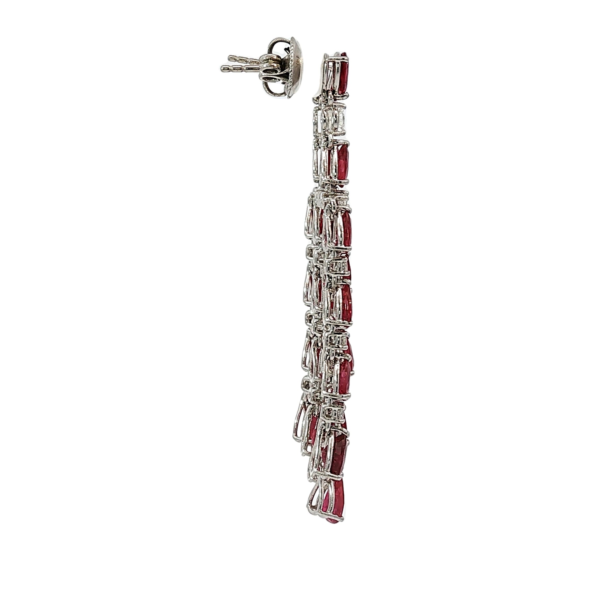 Pear shape ruby and diamond chandelier dangle earrings in 18 karat white gold with 9.98 carats of natural rubies and 1.02 carats of diamonds.