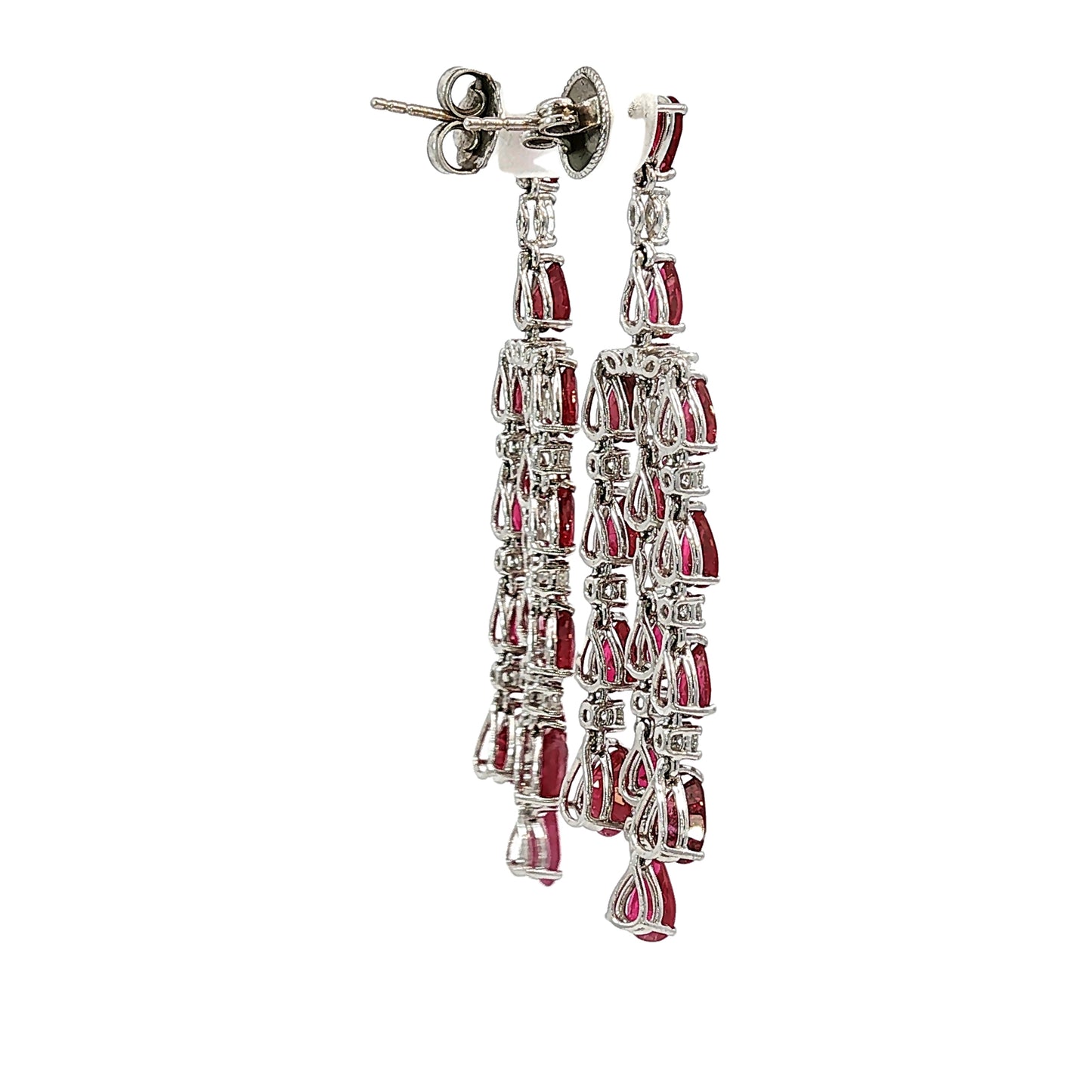 Side profile of 18 karat white gold articulated ruby and diamond chandelier earrings showing open gallery construction and pear-shaped rubies.