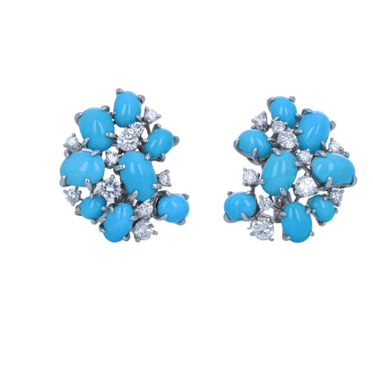 A pair of turquoise stud earrings with silver-toned metal settings, featuring round and oval turquoise cabochons accented with small clear cubic zirconia stones, shown on a plain white background.