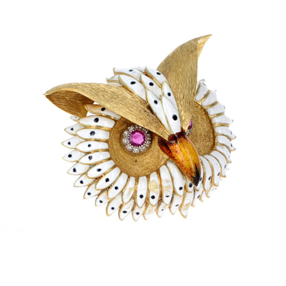 Angled view of handcrafted 18K gold owl brooch highlighting enamel feathers and ruby-set eyes.
