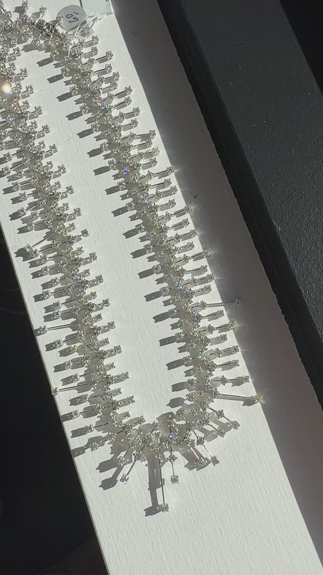 15.50 carat round brilliant diamond fringe chandelier necklace in 18K white gold featuring articulated geometric bars and graduated diamond drops.