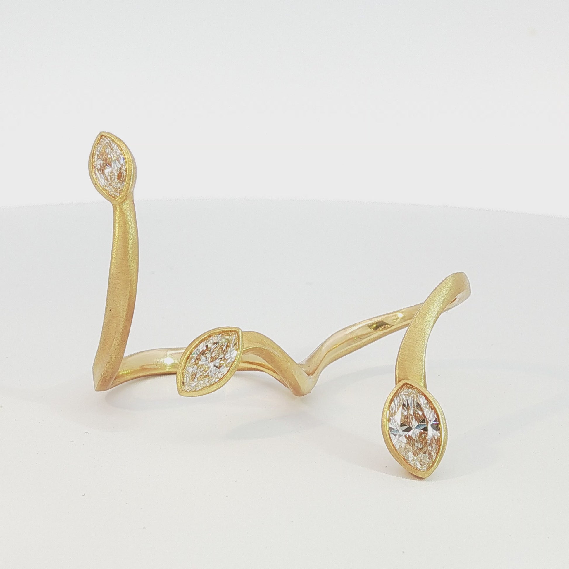 Avant-garde 18k matte yellow gold open-shank ring with 1.53ctw marquise diamonds worn across fingers size 7 by Kantor Gems