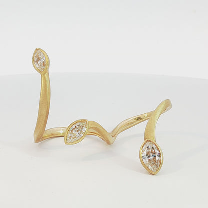 Avant-garde 18k matte yellow gold open-shank ring with 1.53ctw marquise diamonds worn across fingers size 7 by Kantor Gems